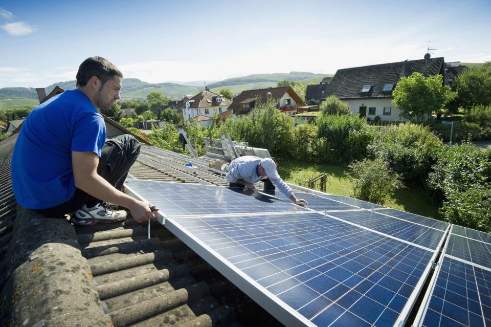 Two persons installing a solar plant, Freiburg im Breisgau, Black Forest, Baden-Wuerttemberg, Germany, Europe