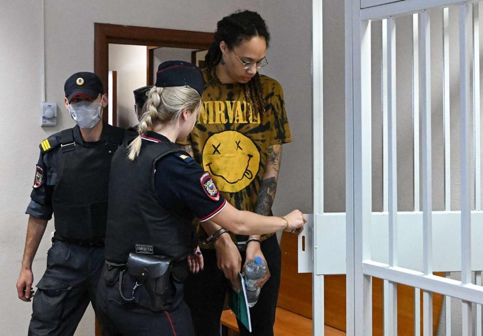 Brittney Griner enters a defendants' cage before a hearing at the Khimki Court in the town of Khimki outside Moscow on July 15, 2022