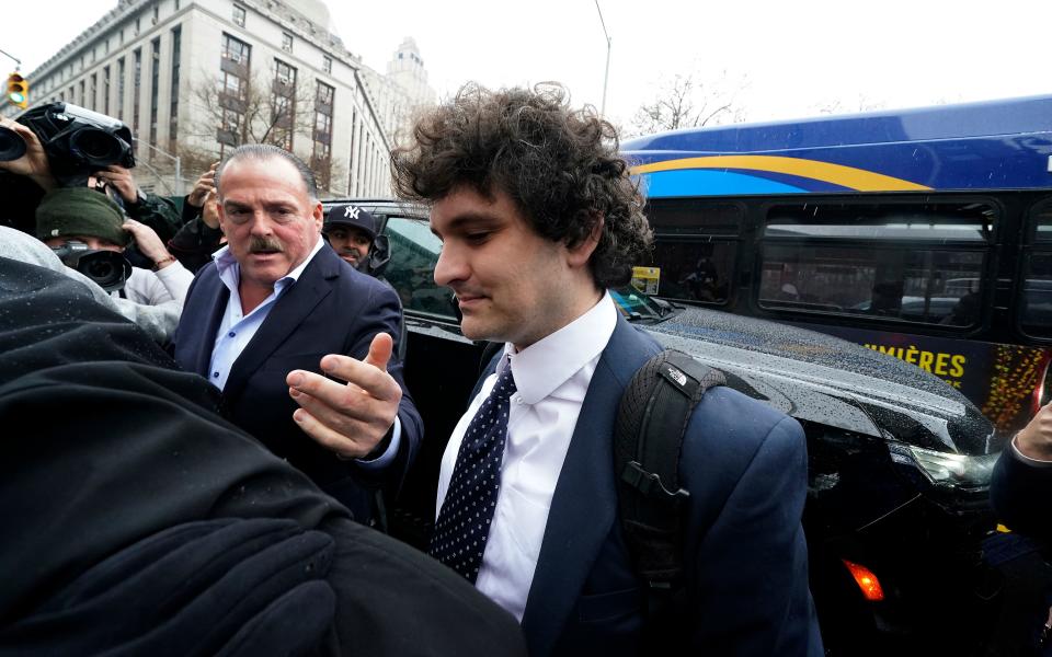 Former FTX chief executive Sam Bankman-Fried (C) arrives to enter a plea before US District Judge Lewis Kaplan in the Manhattan federal court, New York, January 3, 2023. - Bankman-Fried faces criminal fraud charges over the spectacular collapse of his crypto exchange. (Photo by Timothy A. CLARY / AFP) (Photo by TIMOTHY A. CLARY/AFP via Getty Images)