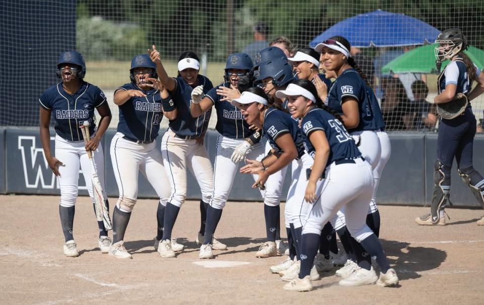 Central Catholic players greet teammate Madison Harrison after she hit three-run home run during the Northern California Regional Division III semifinal playoff game with Pleasant Valley at Central Catholic High School in Modesto, Calif., Thursday, June 1, 2023. Central won the game 8-1.