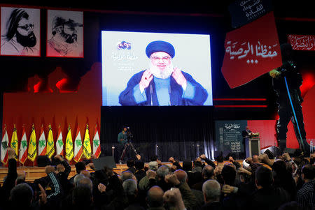 FILE PHOTO: Lebanon's Hezbollah leader Sayyed Hassan Nasrallah is seen on a video screen as he addresses his supporters in Beirut, Lebanon February 16, 2018. REUTERS/Aziz Taher/File Photo