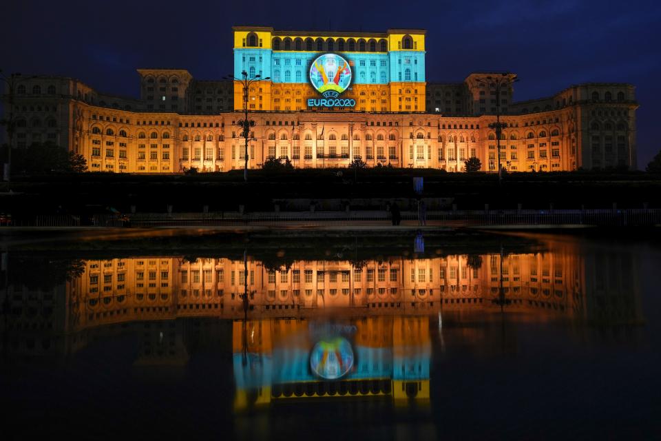 A Euro 2020 themed video mapping is projected on the facade of the communist era built Palace of Parliament, formerly known as the House of the People, in Bucharest, Romania, Friday, June 11, 2021, two days before the city hosts its first game between Austria and North Macedonia. (AP Photo/Vadim Ghirda)