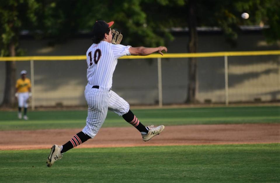 Merced High School shortstop Riley Dickey tries to throw out a hitter at first base during the Merced County All-Star Baseball Game on Saturday, June 10, 2023 at Merced College.