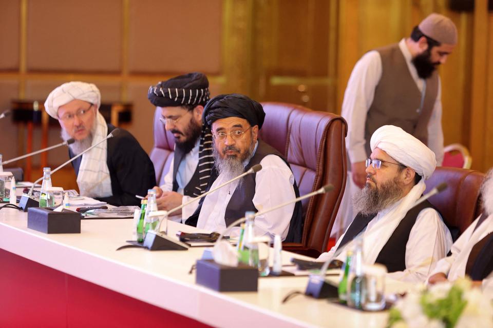 Members of the Taliban delegation look on during the presentation of the final declaration of the peace talks between the Afghan government and the Taliban in Qatar's capital Doha on July 18, 2021.