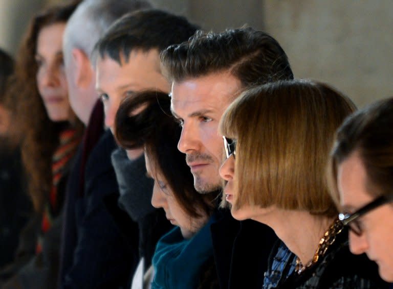 David Beckham (C) sits next to Vogue magazine editor Anna Wintour (2nd R) at the Victoria Beckham show during the Mercedes-Benz Fashion Week Fall 2013 collections on February 10, 2013 in New York