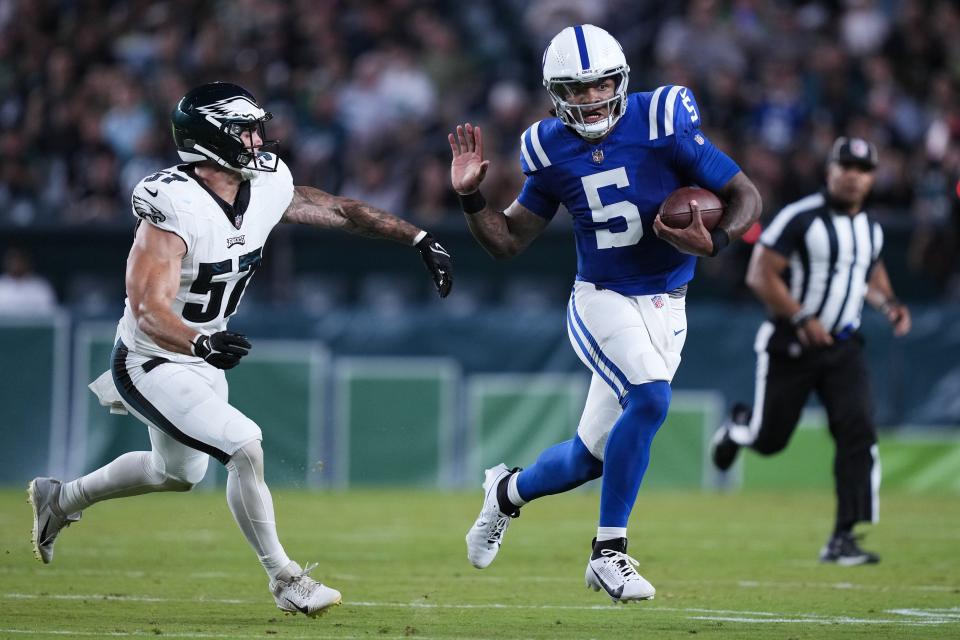 Indianapolis Colts quarterback Anthony Richardson (5) runs with the ball under pressure from Philadelphia Eagles linebacker Ben VanSumeren (57) during the first half of an NFL preseason football game Thursday, Aug. 24, 2023, in Philadelphia. (AP Photo/Matt Rourke)