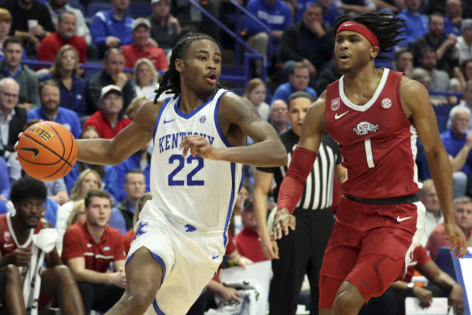 Kentucky's Cason Wallace (22) drives while defended by Arkansas' Ricky Council IV (1) during the first half of an NCAA college basketball game in Lexington, Ky., Tuesday, Feb. 7, 2023. (AP Photo/James Crisp)