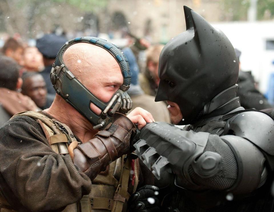 Tom Hardy, as Bane, battles Batman in the Dark Knight Rises - Credit: Rex