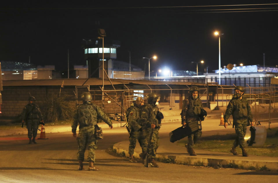 Soldiers leave the prison "Centro de Rehabilitacion Social Regional Centro Norte Cotopaxi" where deadly riots broke out inside, two days prior in Latacunga, Ecuador, early Thursday, Feb. 25, 2021. Ecuador experienced its deadliest prison riots ever this week when seemingly coordinated fights broke out in facilities in three different cities, leaving 79 inmates dead as of Wednesday and exposing the limited control that authorities have over people behind bars. (AP Photo/Dolores Ochoa)