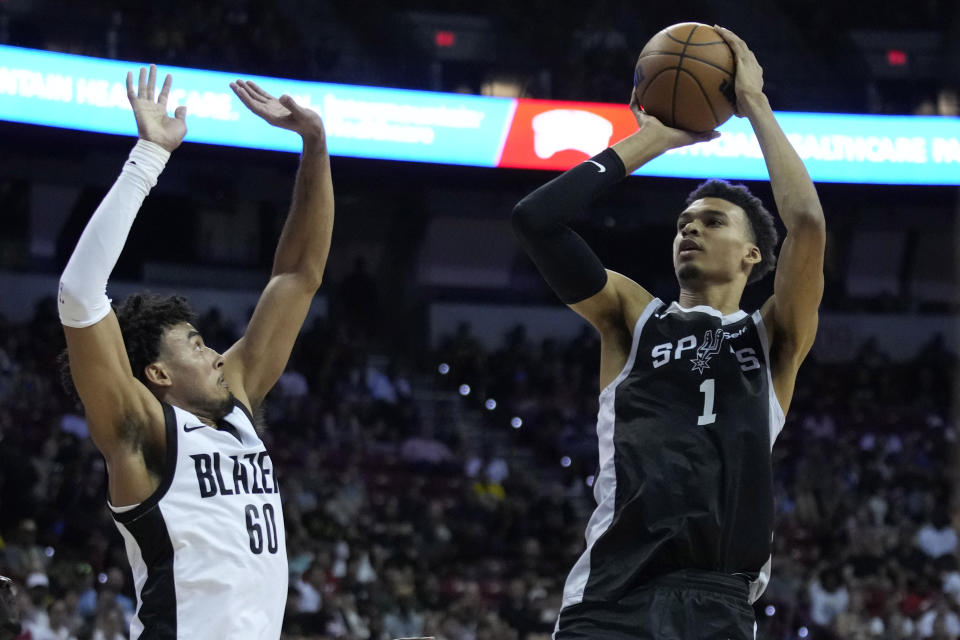 San Antonio Spurs' Victor Wembanyama shoots over Portland Trail Blazers' Justin Minaya during the second half of an NBA summer league basketball game Sunday, July 9, 2023, in Las Vegas. (AP Photo/John Locher)