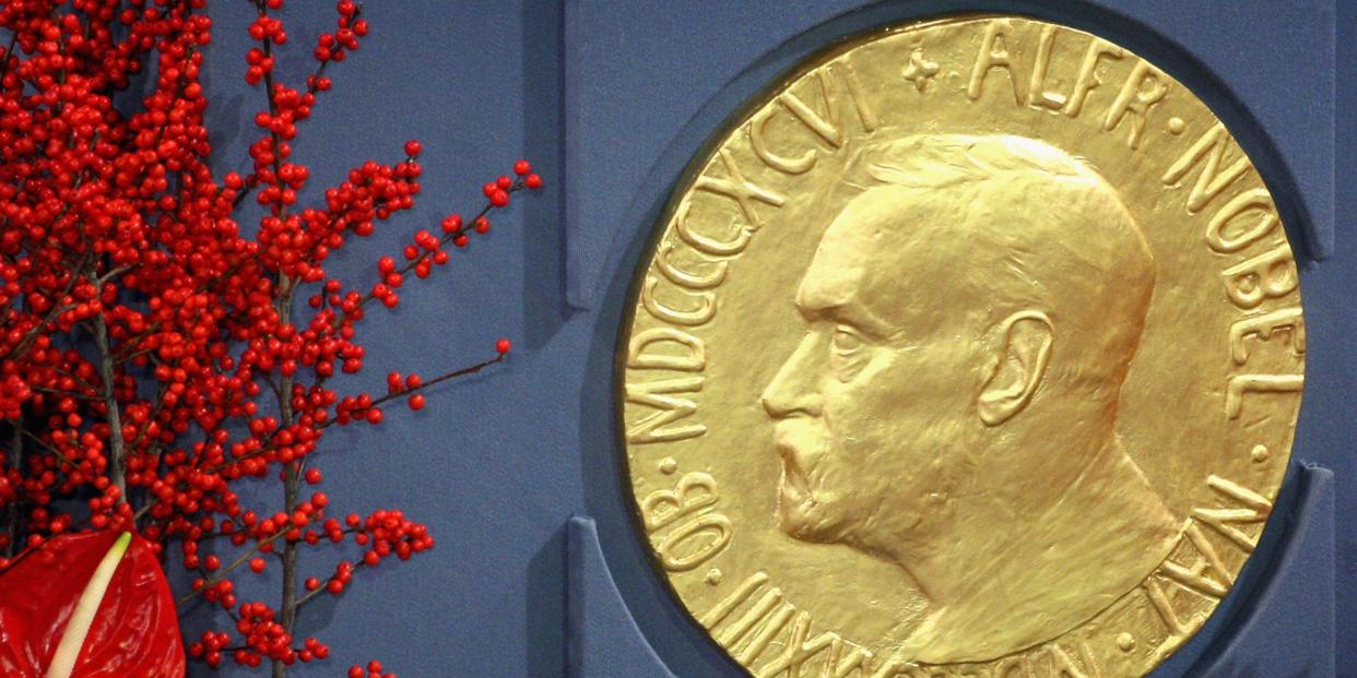 red flowers on left and big gold coin to the right with man's profile on it