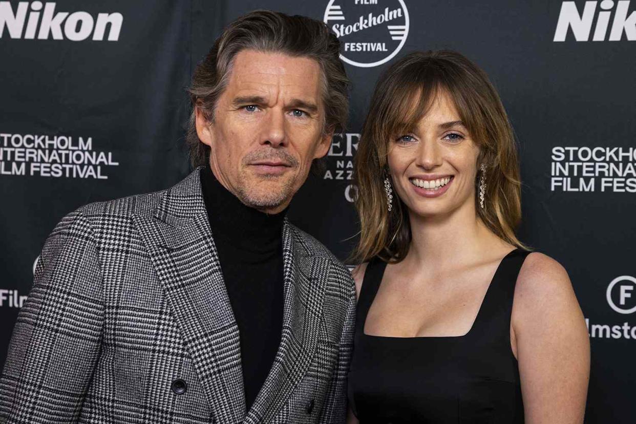 <p>Michael Campanella/Getty Images</p> Ethan Hawke and Maya Hawke pose on the red carpet during a ceremony for the Stockholm Film Festival