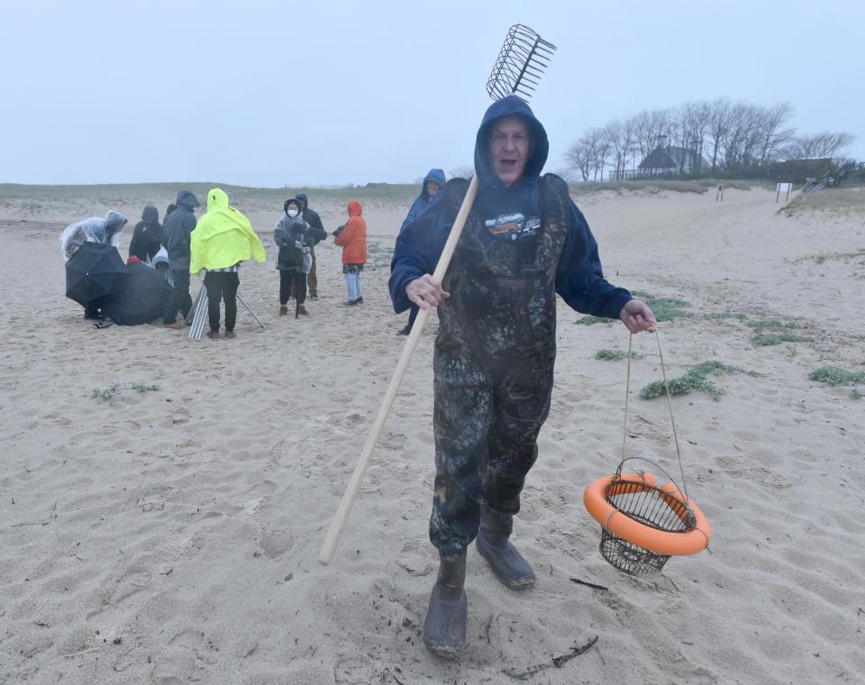 Comedian Lenny Clarke offers a few wisecracks as he heads to the water in a downpour Tuesday to film a scene at Chatham Lighthouse Beach for a short film.