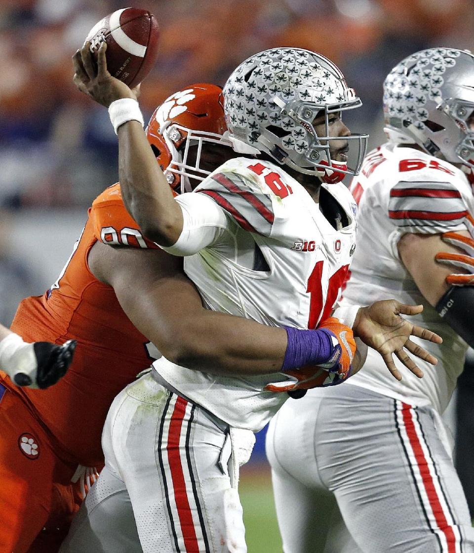 Ohio State quarterback J.T. Barrett (16) is hit by Clemson defensive tackle Dexter Lawrence during the first half of the Fiesta Bowl NCAA college football game, Saturday, Dec. 31, 2016, in Glendale, Ariz. (AP Photo/Ross D. Franklin)