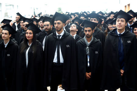 Students wearing mortar board hats wait to receive their degree diplomas following a graduation ceremony for students at University of Rabat, Morocco, February 2, 2019. Picture taken February 2, 2019. REUTERS/Youssef Boudlal