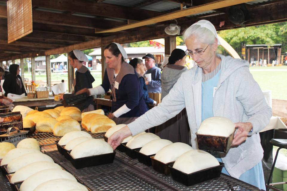 Bernard Orendorf gets the oven hot for the unbaked loaves of bread during last year's Springs Folk Festival.