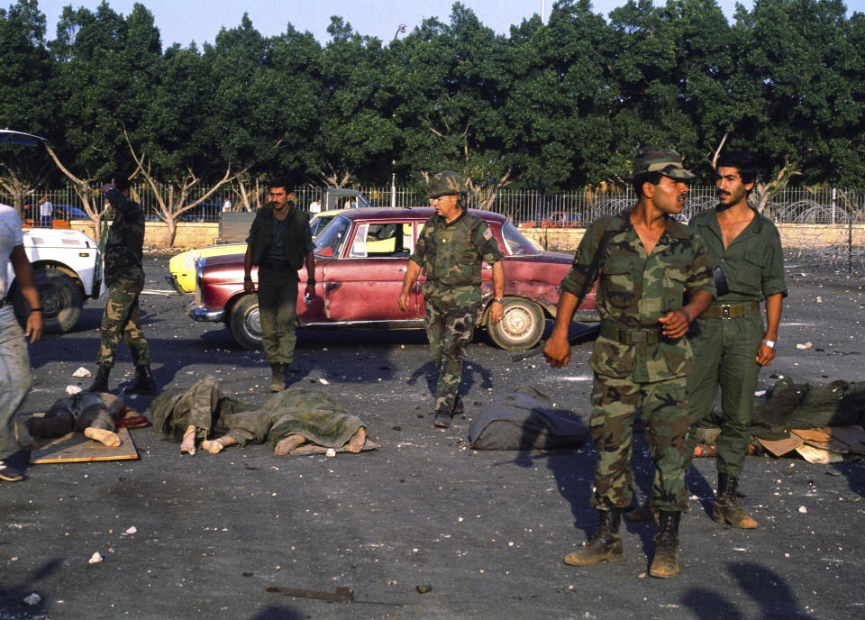 File - Bodies are removed from the U.S. Marine base near Beirut airport on Oct. 23, 1983, following a massive bomb blast that destroyed the base and caused a huge death. Forty years after one of the deadliest attacks against U.S. troops in the Middle East, some warn that Washington could be sliding toward a new conflict in the region. (AP Photo/Hussein Ammar/File)