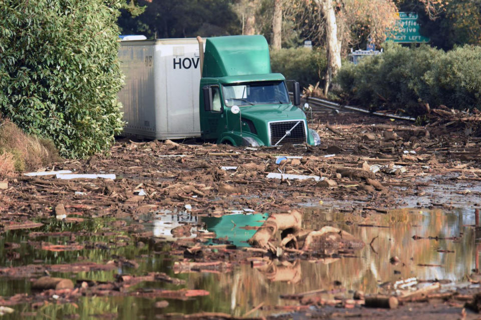 <p>A semi-tractor trailer sits stuck in mud on U.S. Highway 101, in Montecito, Calif. on Tuesday, Jan. 9, 2018. (Photo: Mike Eliason/Santa Barbara County Fire Department via AP) </p>