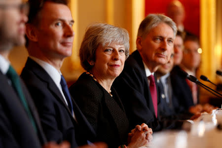 Britain's Prime Minister Theresa May sits with members of her cabinet, including Secretary of State for Defence Gavin Williamson, Secretary of State for Foreign and Commonwealth Affairs Jeremy Hunt, Chancellor of the Exchequer Philip Hammond, Secretary of State for the Home Department Sajid Javid and Secretary of State for Business, Energy and Industrial Strategy Greg Clark during the UK-Poland Inter-Governmental Consultations at Lancaster House in central London, Britain, December 20, 2018. Adrian Dennis/Pool via REUTERS/Files