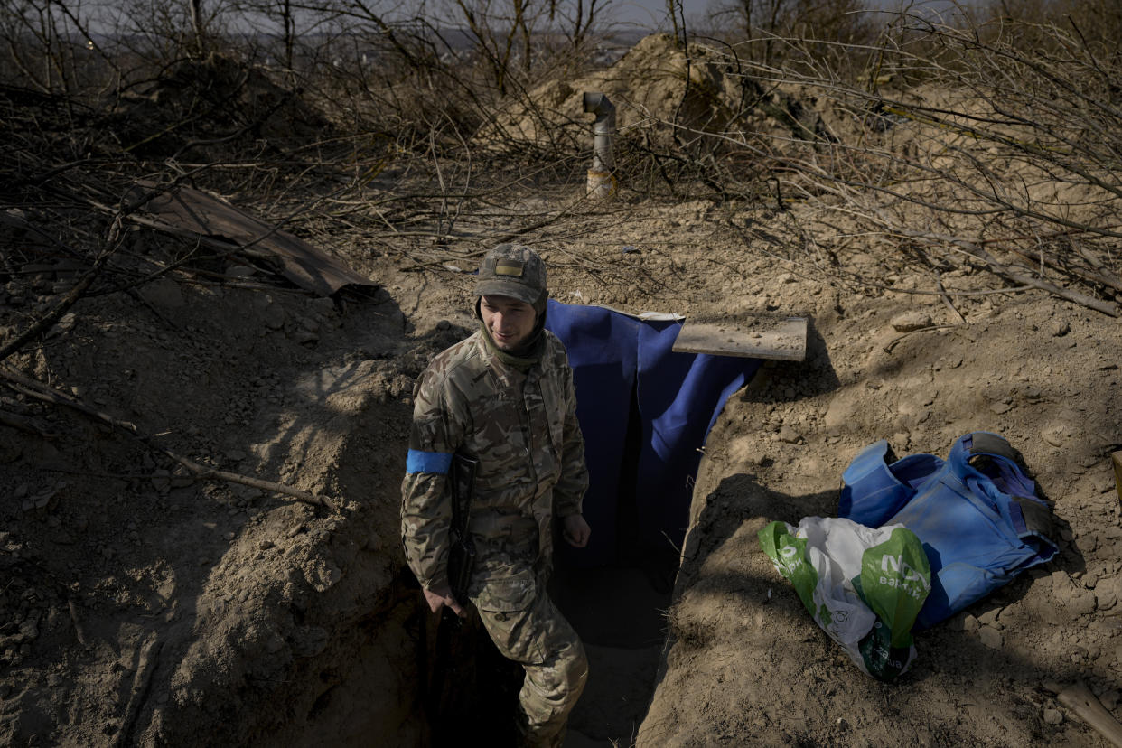 A Ukrainian serviceman stands outside a bunker on the outskirts of Kyiv, Ukraine, Sunday, March 20, 2022. (AP Photo/Vadim Ghirda)