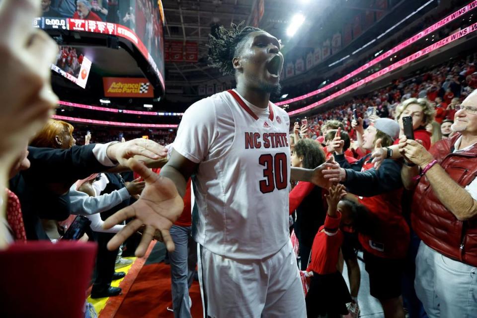N.C. State’s D.J. Burns Jr. (30) celebrates as he comes off the court after N.C. State’s 77-69 victory over UNC at PNC Arena in Raleigh, N.C., Sunday, Feb. 19, 2023.