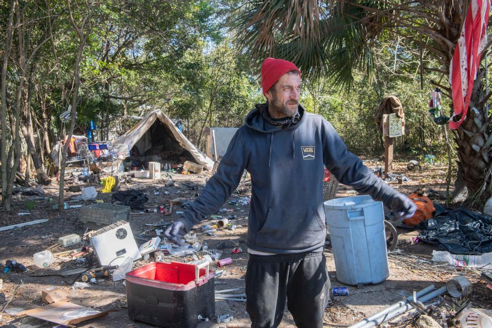 Tom Tom, one of the unhoused people living off Beggs Lane, describes living at the campsite near the Escambia Wood Superfund site off Palafox Street on Friday, Feb. 2, 2024.