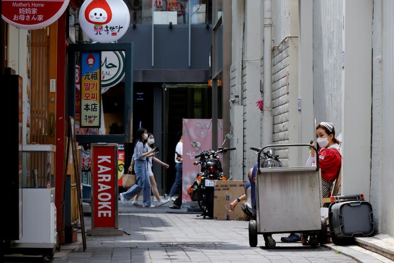 An employee takes a break outside a shop amid the coronavirus disease (COVID-19) pandemic in Seoul