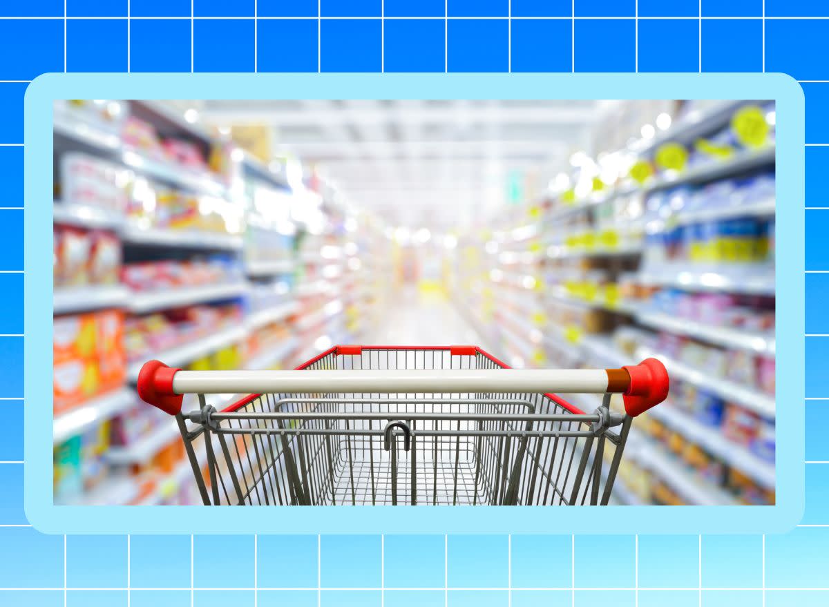 Shopping cart in grocery store with gradient blue background