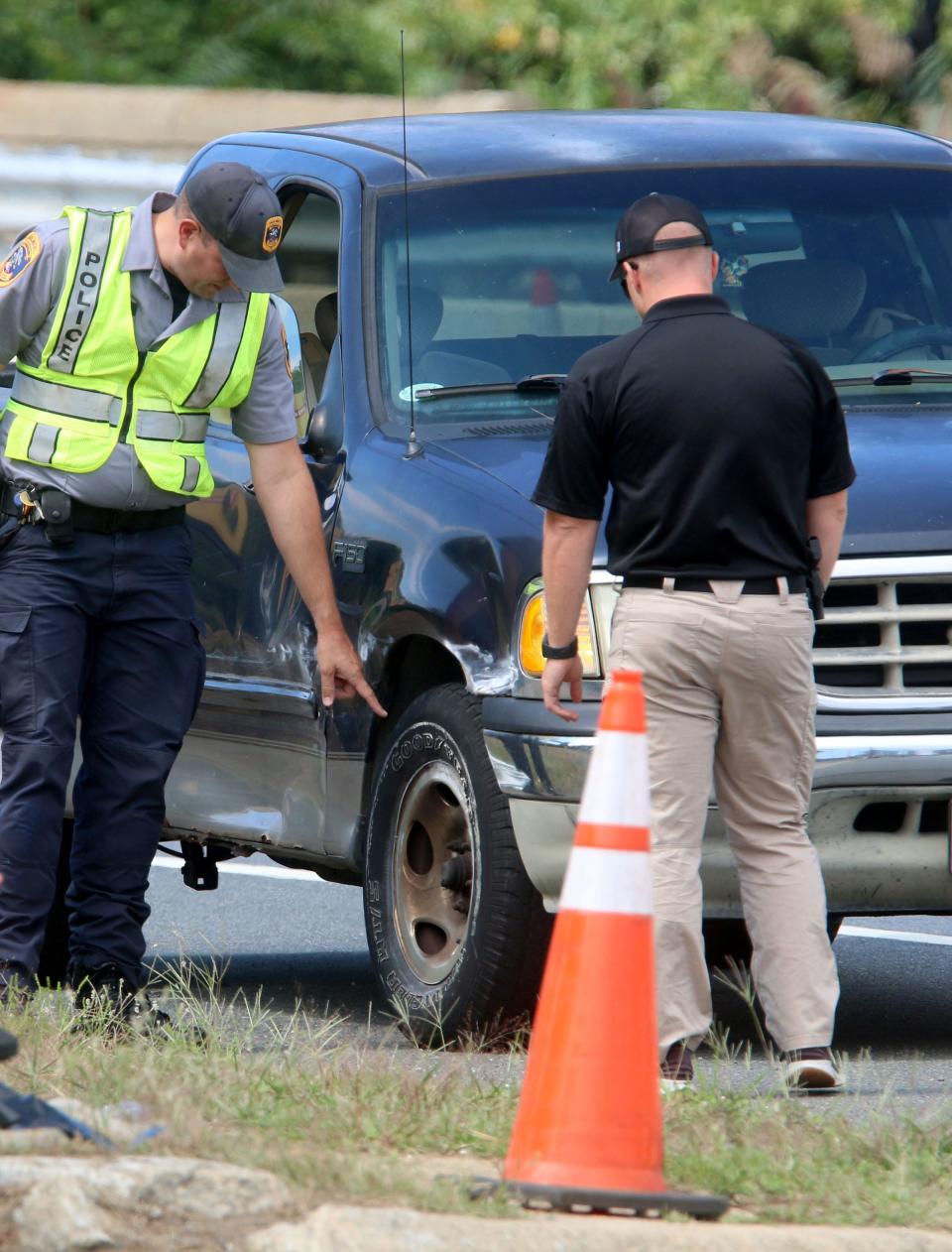 Police examine damage on a pickup truck after a mother and child were struck a vehicle along Route 36 eastbound, just west of Palmer Avenue, in Hazlet Thursday, September 8, 2022.