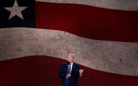 President of the United States, Donald Trump reads from the 32nd U.S. President President Franklin D. Roosevelt's prayer to the US on stage during the D-Day Commemorations - Credit: Getty