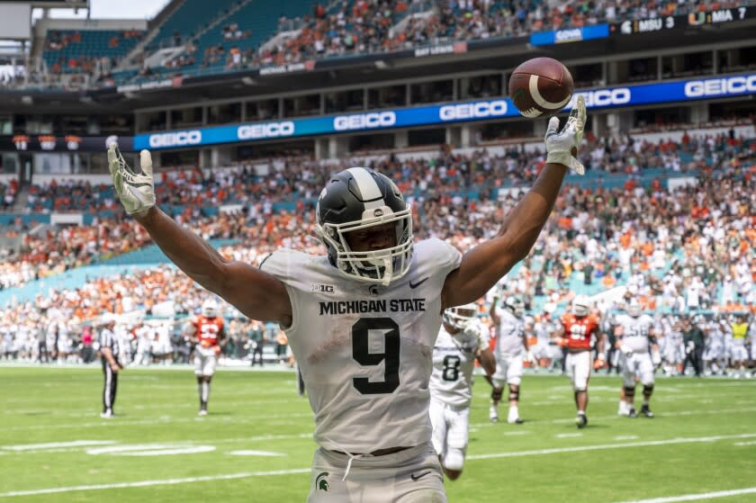 Michigan State running back Kenneth Walker III (9) celebrates scoringt a touchdown against Miami during an NCAA football game on Saturday, Sept 18, 2021 in Miami Gardens, Fla. (AP Photo/Doug Murray)