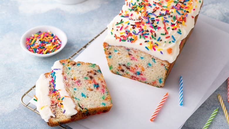 A Funfetti cake on a wire baking rack.