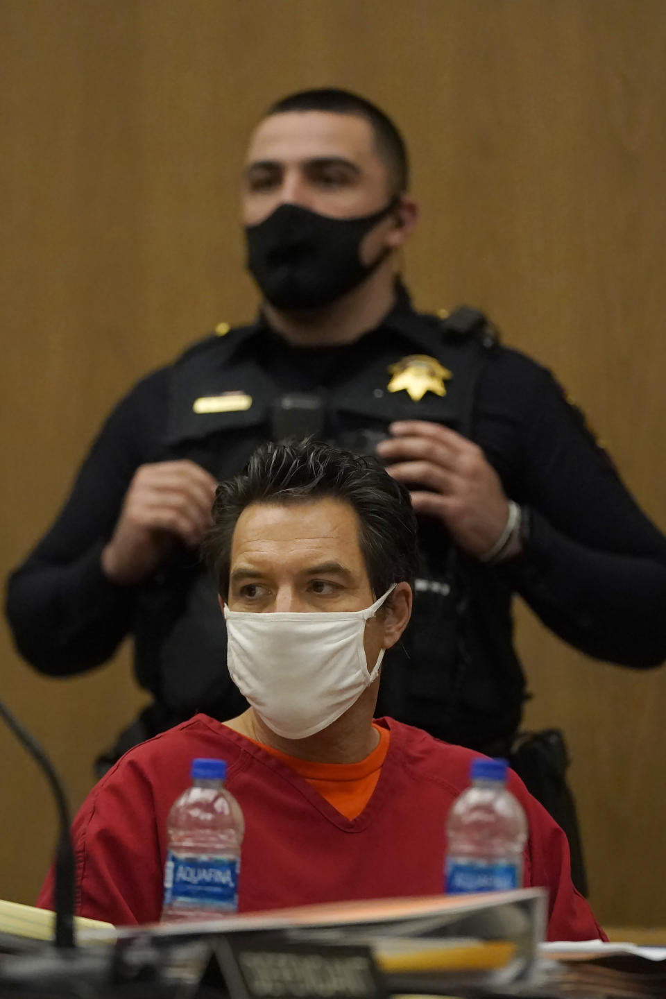 Scott Peterson, bottom, sits during a hearing at San Mateo County Superior Court in Redwood City, Calif., Monday, Feb. 28, 2022. Lawyers trying to overturn Peterson’s conviction in the sordid slaying of his pregnant wife 20 years ago completed their questioning Monday without shaking a former juror from her crucial testimony that she acted properly before and during his 2004 trial. (AP Photo/Jeff Chiu, Pool)