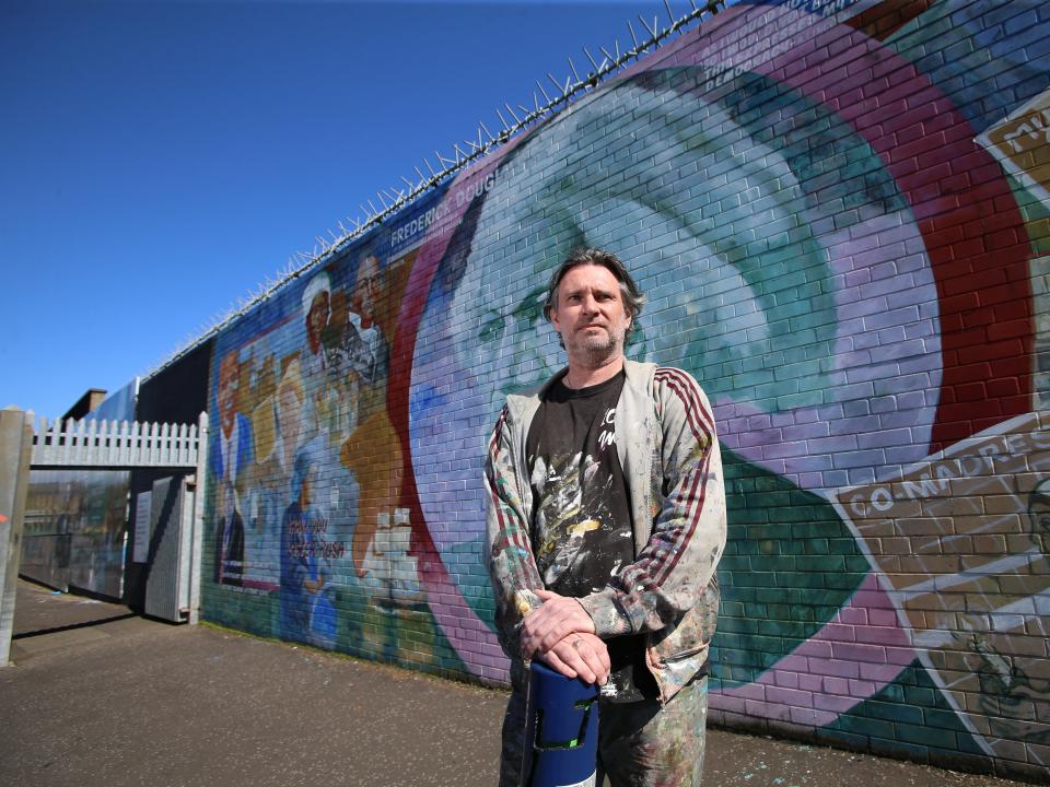 Mark Ervine, street artist and son of the late Progressive Unionist Party (PUP) leader David Ervine, stands near a mural he worked on on the peace line in West BelfastPaul McErlane