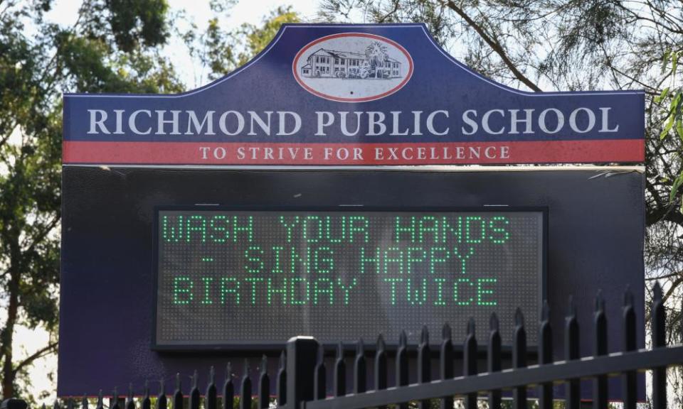 A sign outside a Sydney school asking children to sing happy birthday twice while washing their hands