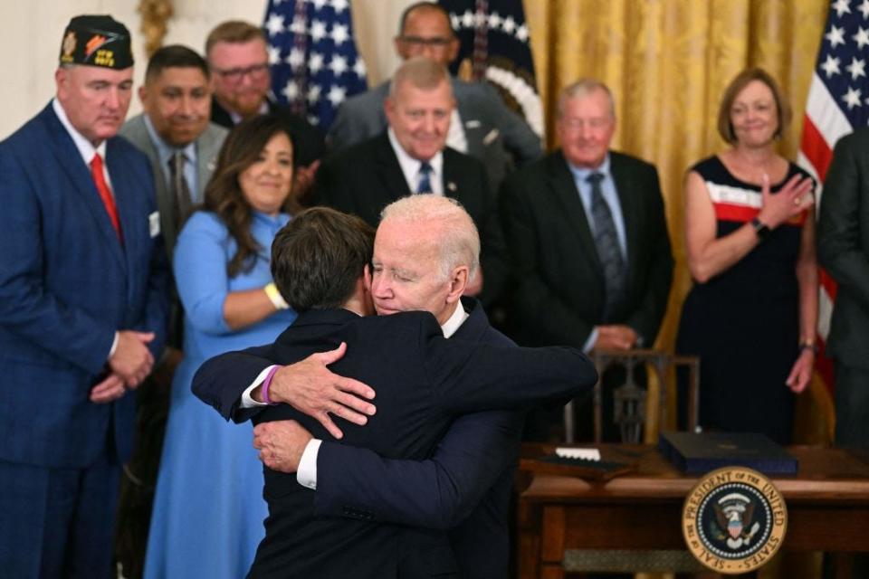 Joe Biden embraces his grandson in the East Room of the White House