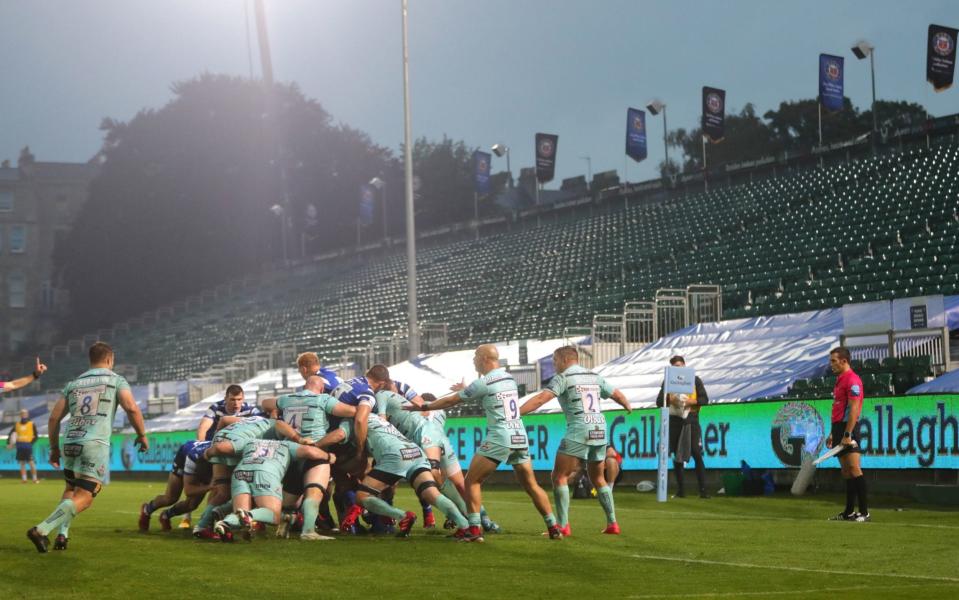 Bath and Gloucester players scrum in front of an empty stand during the Gallagher Premiership match at the Recreation Ground - PA