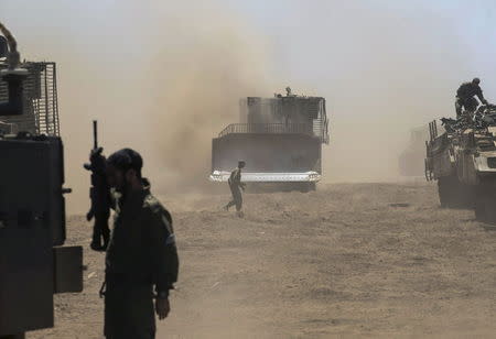 Israeli army armoured vehicles are seen during an exercise in the Israeli-occupied Golan Heights, near the ceasefire line between Israel and Syria June 17, 2015. REUTERS/Baz Ratner