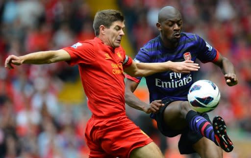 Liverpool midfielder Steven Gerrard (left) vies with Arsenal's Abou Diaby during the Premier League match between Liverpool and Arsenal at Anfield in Liverpool. Arsenal ended their goal drought in emphatic fashion as Lukas Podolski and Santi Cazorla inspired an impressive 2-0 win at Liverpool