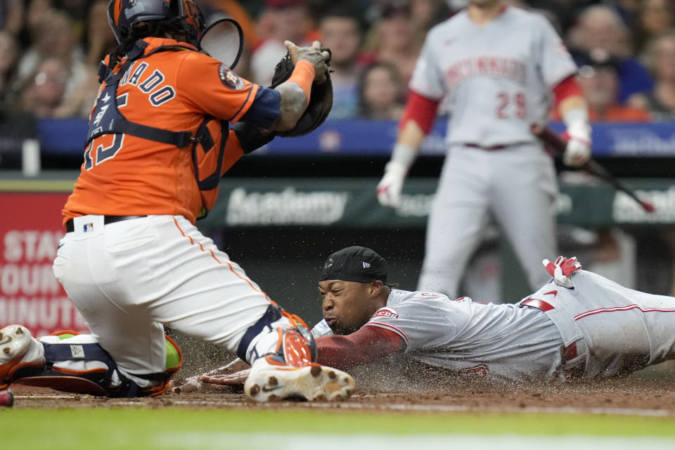 Cincinnati Reds' Will Benson, bottom right, slides home past Houston Astros catcher Martin Maldonado, left, to score on Kevin Newman's RBI-double during the seventh inning of a baseball game, Friday, June 16, 2023, in Houston. (AP Photo/Eric Christian Smith)