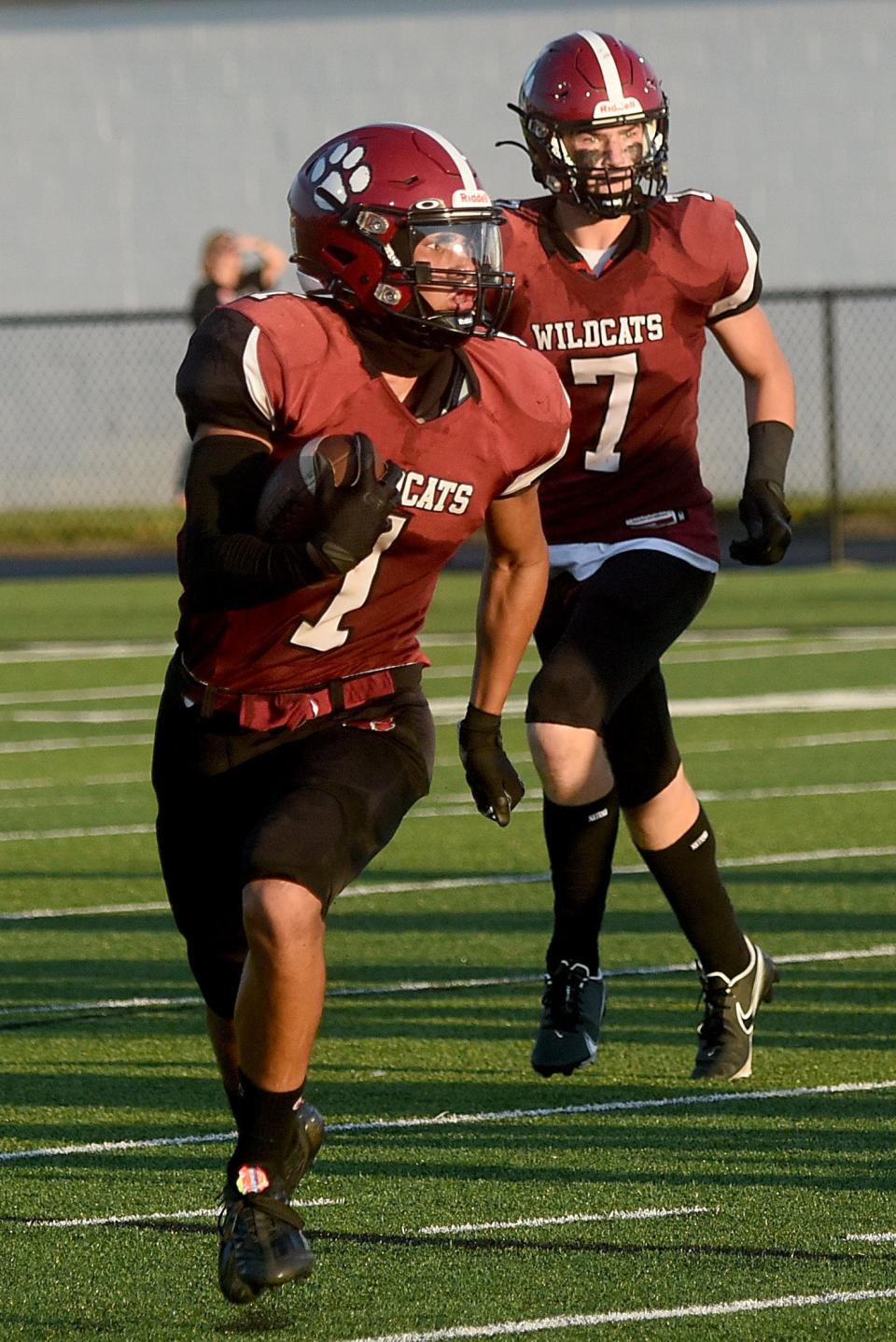 Newark junior Tee Davie (1) races to the outside with sophomore teammate Austin Rose (7) trailing during the Wildcats' season opener against Zanesville. Newark bounced back to beat Mount Vernon 35-34 in Week 2, the program's first victory since 2019.