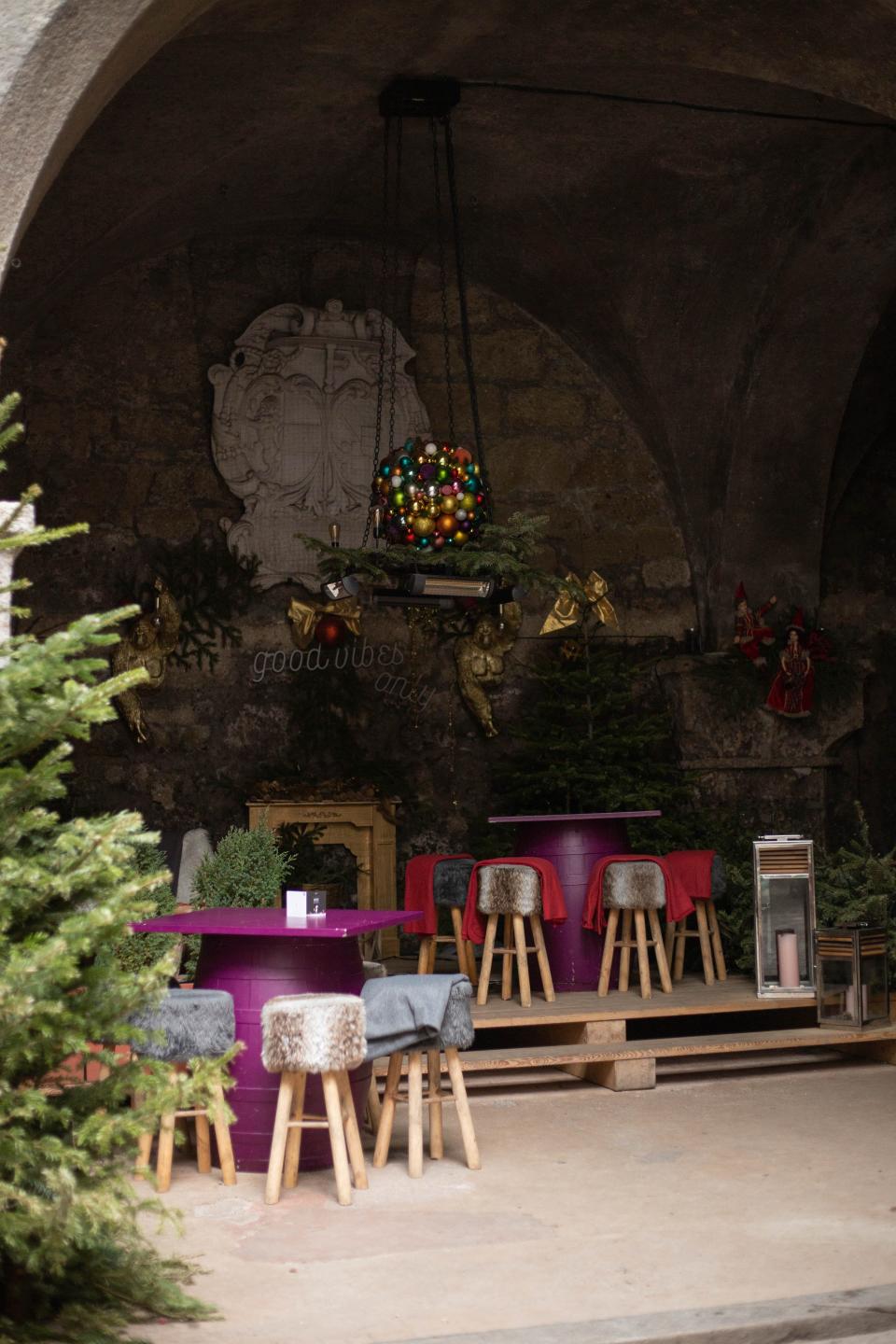 Festive decorations and chairs and tables within an ancient courtyard