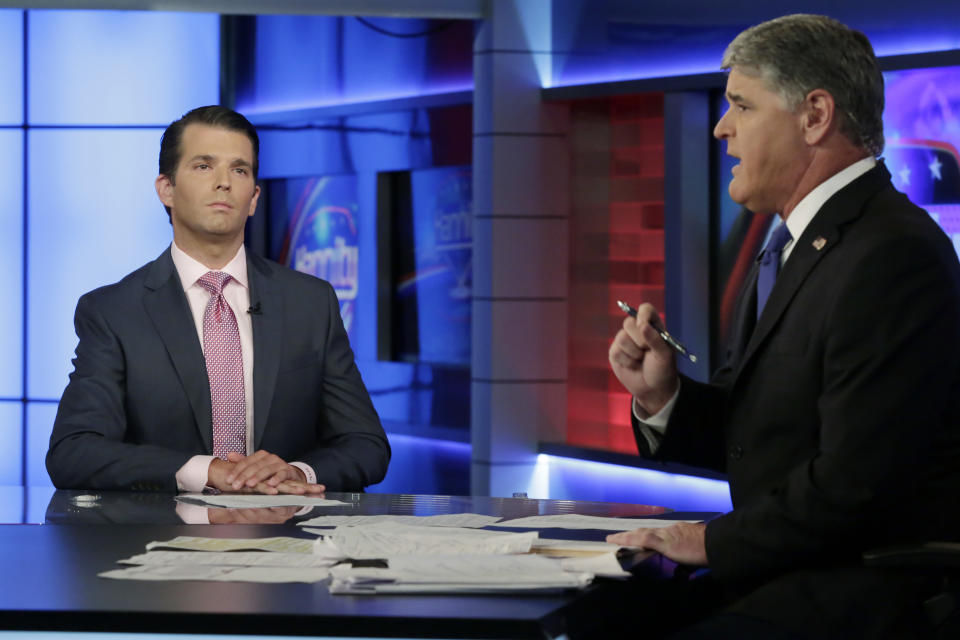 Donald Trump Jr., left, is interviewed by host Sean Hannity on his Fox News Channel television program, in New York Tuesday, July 11, 2017. Donald Trump Jr. eagerly accepted help from what was described to him as a Russian government effort to aid his father's campaign with damaging information about Hillary Clinton, according to emails he released publicly on Tuesday. (AP Photo/Richard Drew)