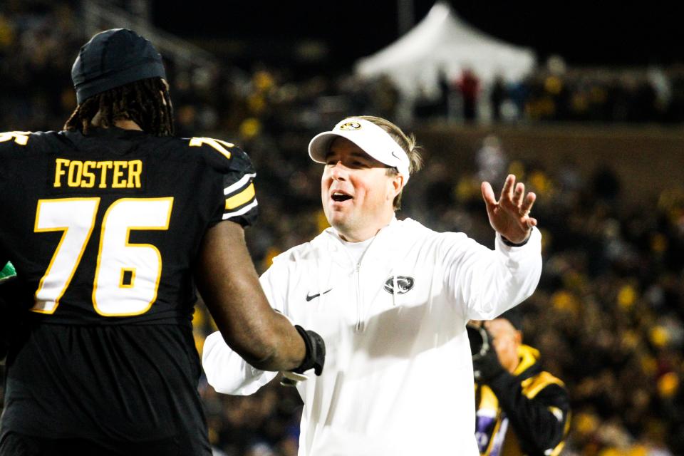 Missouri head coach Eli Drinkwitz shows his elation at senior offensive tackle Javon Foster during the senior day festivities before a college football game at Memorial Stadium on Nov. 18, 2023, in Columbia, Mo.