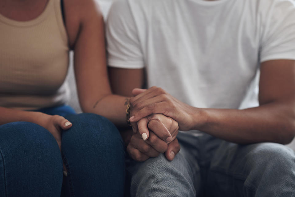 A man and woman holding hands