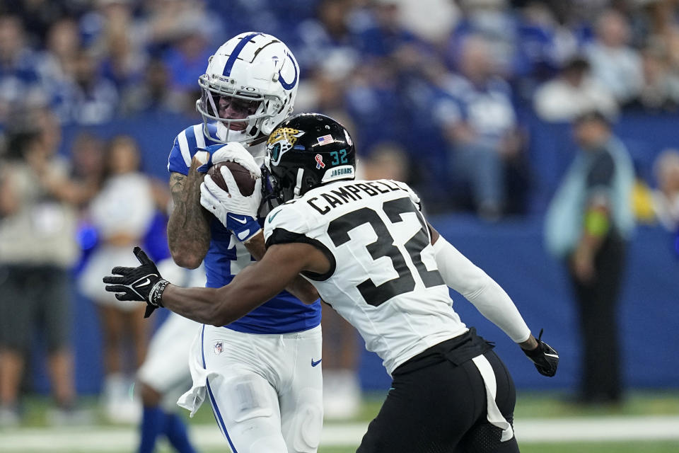 Indianapolis Colts wide receiver Michael Pittman Jr. catches a pass as Jacksonville Jaguars cornerback Tyson Campbell (32) defends during the second half of an NFL football game Sunday, Sept. 10, 2023, in Indianapolis. (AP Photo/Darron Cummings)