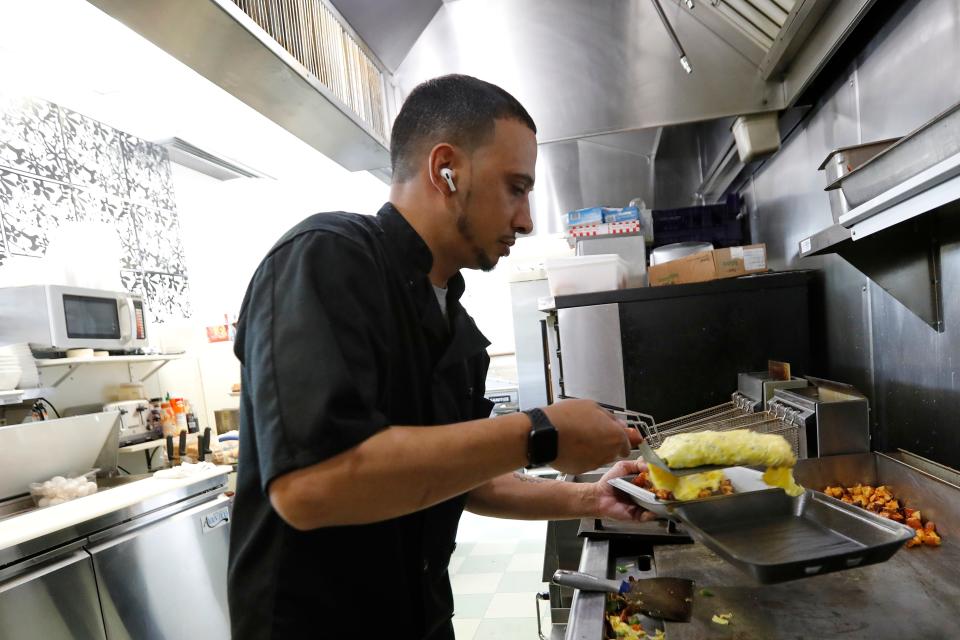 Jason Brooks prepares a vegetable omelet to go at the newly opened What's Cookin on Acushnet Avenue in New Bedford.