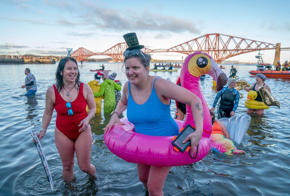 People take part in the Loony Dook New Year's Day dip in the Firth of Forth at South Queensferry, as part of Edinburgh's Hogmanay celebrations. (PA)