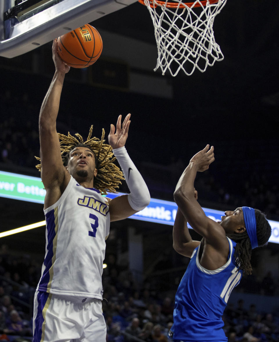 James Madison forward T.J. Bickerstaff (3) takes a shot over Buffalo guard Shawn Fulcher (10) during the first half of an NCAA college basketball game in Harrisonburg, Va., Wednesday, Nov. 29, 2023. (Daniel Lin/Daily News-Record via AP)