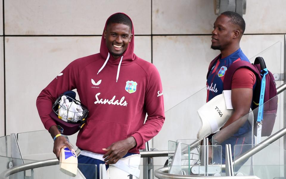 West Indies captain Jason Holder heads out to bat with Nkrumah Bonner on Wednesday - GETTY IMAGES